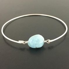 Larimar Nugget Bead Bracelet -  Light Blue Bracelet Bangle. Each Larimar nugget is a little different in its light blue color placement and faint white veining but all of them are incredible. They remind me of light foamy ocean waves. Each bead is about 14mm in size and will be transformed into an elegant Larimar beaded bangle bracelet with your choice of bangle band in sterling silver, silver filled, brass, 14k gold filled or 14k rose gold filled. This Blue Larimar jewelry can be personalized w Larimar Bracelet Jewelry Gift, Handmade Adjustable Larimar Bracelets, Turquoise Larimar Bracelet, Turquoise Larimar Bracelets For Gifts, Turquoise Larimar Bracelets As A Gift, Adjustable Blue Larimar Jewelry, Adjustable Turquoise Larimar Beaded Bracelets, Blue Hypoallergenic Bangle Jewelry, Blue Larimar Hypoallergenic Jewelry