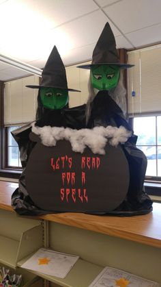 two green witches sitting on top of a black bag with the words let's read for a spell