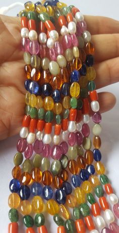 "PRODUCT DESCRIPTION :--  Stone Name : Natural Navratan  Gemstone Shape:-- oval ( smooth )  Length : 18\"Inches Approximate  Color : Multi  Quality: AAA  Size : 5-6 MM  Stones Names :- Ruby, Pearl, Italian coral, Emerald, Yellow sapphire, Blue sapphire, Hessonite, Cat's eye... The photographs of the items have been taken in natural daylight, without any enhancements or affects and all attempts have been made to depict the colour of the gemstones accurately. Due to the use of natural gemstones, gemstone colours may vary slightly." Multicolor Natural Stones Oval Beads, Multicolor Oval Natural Stone Beads, Multicolor Natural Stones Beads, Multicolor Natural Oval Gemstone Beads, Multicolor Oval Natural Gemstone Beads, Multicolor Natural Oval Bead Gemstones, Polished Oval Beads Gems And Cabochons For Gift, Oval Faceted Beads For Jewelry Making, Oval Natural Stone Beads For Gifts