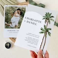 someone holding up a wedding card with a palm tree on the front and back side