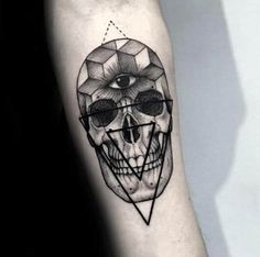 a man's arm with a skull tattoo on it