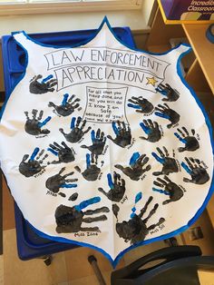 the law enforcement appreciation sign is made with handprints from children's hands