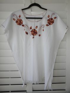 "Width - 30\" shoulder-to-shoulder; Length - 26\" long (Large/Extra Large) 100% Manta (cotton material that wears like a linen). Great for hot weather. Hand-wash or turn inside-out on your machine's delicate cycle Ask me about international shipping!" Brown Cotton Top With Floral Embroidery, Traditional Brown Summer Tops, Summer Cotton Blouse In Brown, Traditional Cotton Blouse With Tassels, Bohemian Cotton Blouse With Fringe, Short Sleeve Cotton Blouse With Tassels, Bohemian Brown Cotton Blouse, Cotton Short Sleeve Blouse With Tassels, White Cotton Top With Tassels