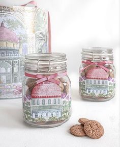 two jars filled with cookies next to each other