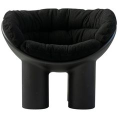 a black dog bed sitting on top of a stool