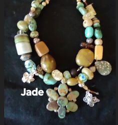 "Jade" Jaw dropping wow factor... one of a kind turquoise necklace! The unique pendant is highlighted by a combination of turquoise stones in a variety of shapes and  colors, tumbled stone, tiger eye and glass has been beaded in. A old African trading bead adds some interest. A couple of fun dangles add some eye candy. Go ahead... be unique.. wear art and rock your look! Measures 17 inches from end to end. Hook closure. Your jewelry should always make you smile.. Item # 337 Handmade Turquoise Dangle Necklace, Artisan Beaded Jade Jewelry, Artisan Jade Beaded Jewelry, Green Multi-strand Spiritual Jewelry, Unique Turquoise Jewelry With Gemstone Beads, Green Spiritual Multi-strand Jewelry, Handmade Bohemian Jade Jewelry, Green Bohemian Double Strand Jewelry, Turquoise Double Strand Hand-strung Jewelry