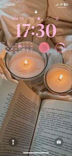 an open book with two candles on top of it and the number three 3 53