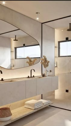 a modern bathroom with two sinks and mirrors