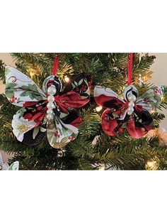 a christmas tree decorated with red, white and black bow ornaments hanging from it's branches