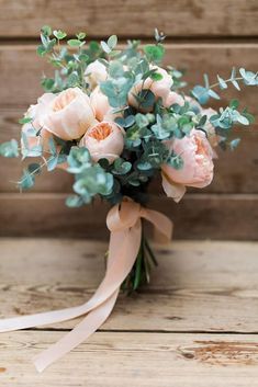 a bouquet of flowers sitting on top of a wooden table next to an instagram