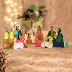 wooden nativity figurines sitting on top of a table