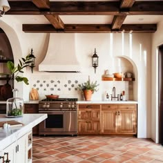 a kitchen with an oven, stove and counter top in the center is tiled flooring