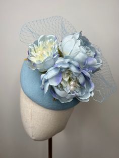 A gorgeous blue felt fascinator featuring a cluster of beautiful artificial ombré blue peonies and Pearl centres and matching veil. This beautiful fascinator sits on an elastic hat band. This classic fascinator is perfect for any formal occasion, weddings and races. Brand New. The felt fascinator measures approximately 15cm in diameter. If you need your item by a certain date please let me know. Made in the UK. Custom orders are welcome. Many more items are available in our Shop. Returns Please notify us within 3 days of receiving your item if you intend to return it. We allow 7 days from the date of receipt of the headpiece to return it to us, our returns requirements are that it is returned properly packaged to prevent damage in the post, it is unworn/as new condition and has not had the Light Blue Fascinator, Spring Blue Mini Hats With Handmade Flowers, Blue Headpieces For Spring Weddings, Light Blue Headpieces For Spring Wedding, Blue Wedding Fascinator With Handmade Flowers, Felt Fascinator, Blue Fascinator, Blue Peonies, Birdcage Veil