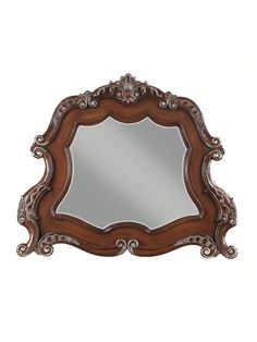 an ornate wooden mirror on a white wall