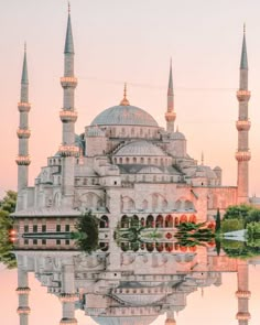 an image of a building that is reflecting in the water