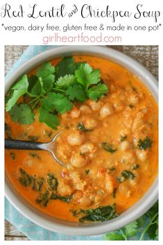 red lentil and chickpea soup in a white bowl with a spoon