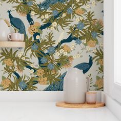 the wallpaper in this kitchen is painted with peacocks and flowers