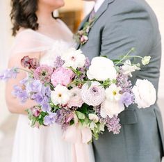 a bride and groom holding a bouquet of flowers