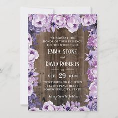 wedding card with purple and white flowers on wooden planks in the center, which reads we request the honor of your presence for the wedding of