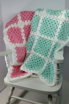 a crocheted blanket sitting on top of a rocking chair