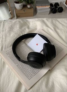 headphones are laying on top of an open book