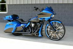 a blue motorcycle parked in front of a building