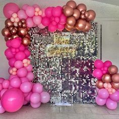 pink and gold balloons in front of a wall