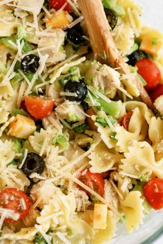 a pasta salad with broccoli, tomatoes, olives and parmesan cheese