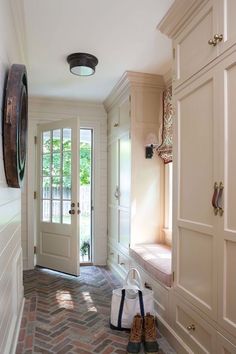 a pair of shoes sitting on the floor in front of a door and some doors