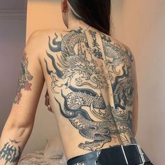 the back of a woman with tattoos on her body