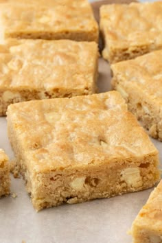 several pieces of cake sitting on top of a piece of parchment paper