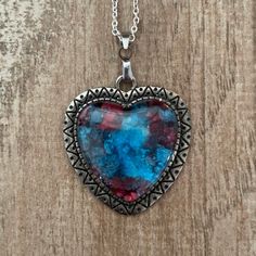 Absolutely stunning heart shape pendant! The turquoise and red ink blends together into such a beautiful combination, so striking! Width: 1 1/4" Height: 1 1/4" Chain: 16" extends to 18" silver cable chain. Valentine's Day Heart Pendant Necklaces, Turquoise Heart Necklace For Valentine's Day, Artistic Silver Heart Necklace, Unique Multicolor Heart Pendant Necklace, Multicolor Metal Heart Pendant Necklace, Multicolor Heart Pendant Metal Necklace, Multicolor Heart Pendant Necklace In Metal, Nickel-free Blue Heart Necklaces, Unique Blue Heart Pendant Necklace