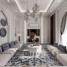 a living room with white couches and blue patterned rugs on the floor, chandeliers hanging from the ceiling