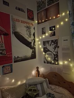 a bedroom with posters and lights on the wall