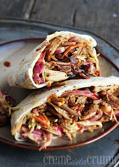 two burritos filled with meat and vegetables on a plate