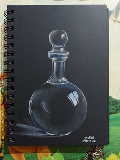 a drawing of a perfume bottle on a notebook