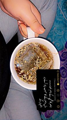 a woman is holding a bowl of food with rice and other foods in the bowl