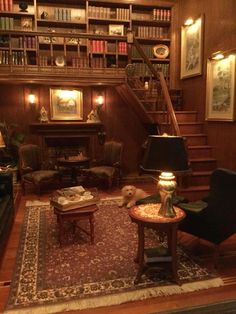 a living room filled with furniture and bookshelves next to a stair case full of books