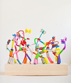 many different colored toothbrushes in a wooden holder