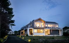 a large house lit up at night in the evening