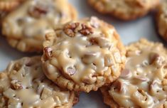 there are many cookies with icing and nuts on them