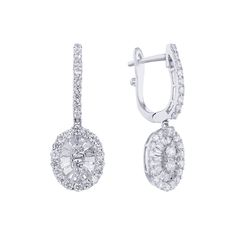 Introducing the exquisite Lark Diamond Drop Earrings from Steven Singer Jewelers. Crafted from 18 karat gold, these earrings feature a stunning oval halo design adorned with a mix of round and baguette diamonds, totaling approximately 1 1/5 carats in weight. The expertly matched round brilliant diamonds add a brilliant sparkle while the baguette diamonds lend a unique and elegant touch. With their delicate yet striking design, the Lark Diamond Drop Earrings are the perfect choice for any special Luxury Diamond Earrings With Baguette Cut Halo Design, Exquisite Oval Brilliant Cut Diamond Earrings, Exquisite Oval Diamond Earrings With Accents, Exquisite Oval Diamond Earrings With Brilliant Cut, Luxury Oval Cluster Earrings For Formal Occasions, Elegant Oval Diamond Cluster Earrings, Luxury Oval Cluster Earrings For Anniversary, Luxury Oval Diamond Earrings With Halo Design, Elegant Round Diamond Earrings With Baguette Diamonds