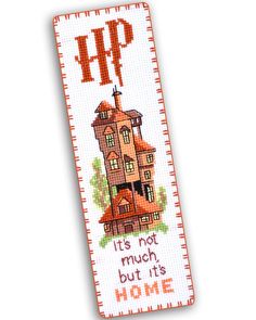 a cross stitch bookmark with an image of a house and the words it's not much but its home