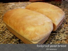 two loaves of bread sitting on top of a cooling rack