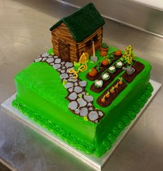 a green cake with a farm scene on it