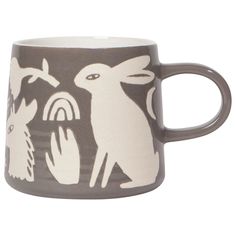 a coffee cup with an animal design on the front and sides, in grey and white