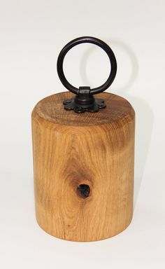 a wooden container with a black ring on top