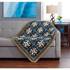 a couch with a blue and white blanket on it