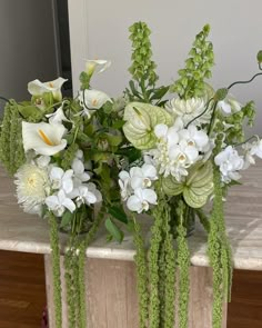 a vase filled with white flowers on top of a table