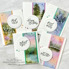 four cards with watercolor trees and the words happy birthday written in white on them